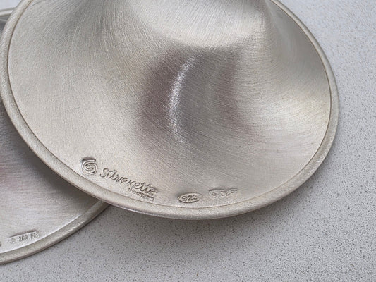 Close-up of the Silverette logo and 925 silver hallmark stamped on the rim of a genuine Silverette nursing cup